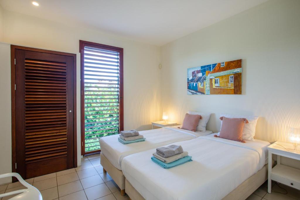 Postel nebo postele na pokoji v ubytování Boca Gentil sea view apartment - Jan Thiel