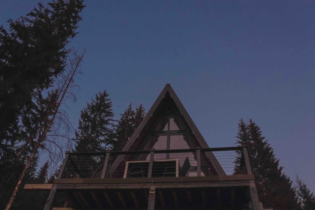 a house with a triangle roof with trees in the background at Vila Panoramic in Cîrlibaba