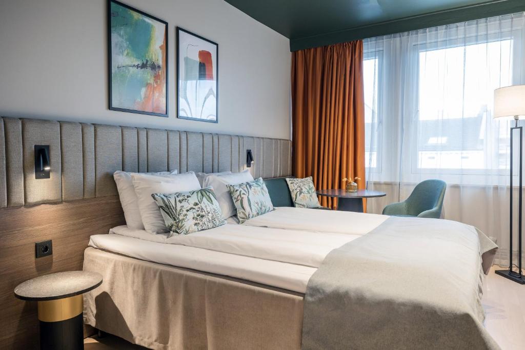 Postel nebo postele na pokoji v ubytování Quality Hotel Prinsen