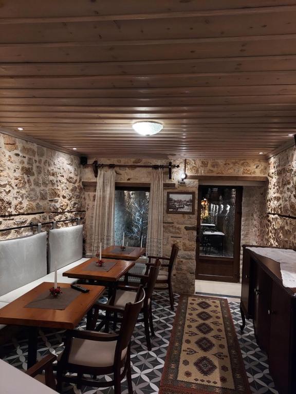 a restaurant with wooden tables and chairs in a room at VIRSA BOUTIQUE ROOMS in Ioannina