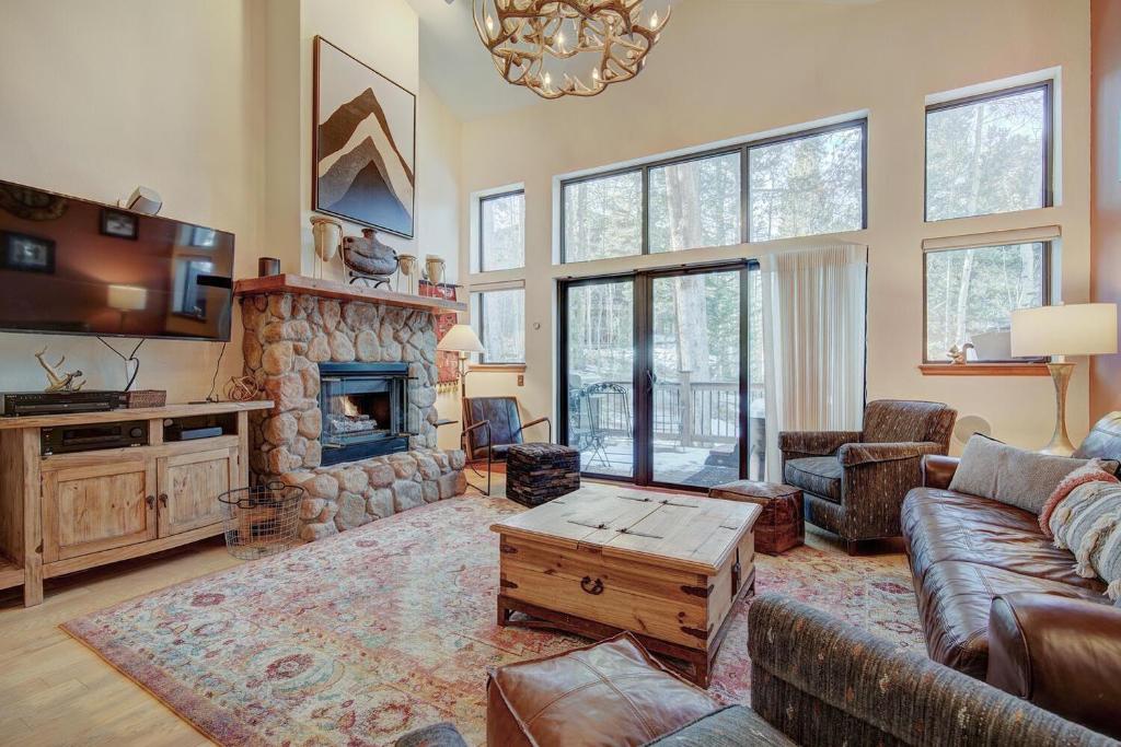 a living room with a couch and a fireplace at Village Point in Breckenridge