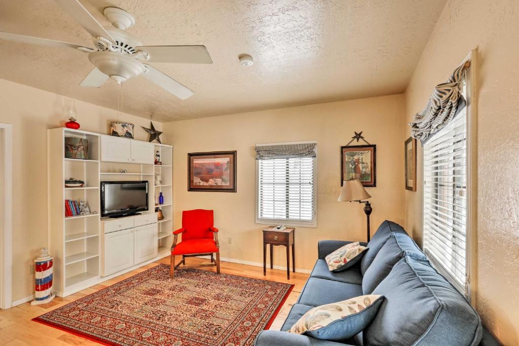 a living room with a blue couch and a red chair at Williams Vacation Rental with Mountain View! in Williams