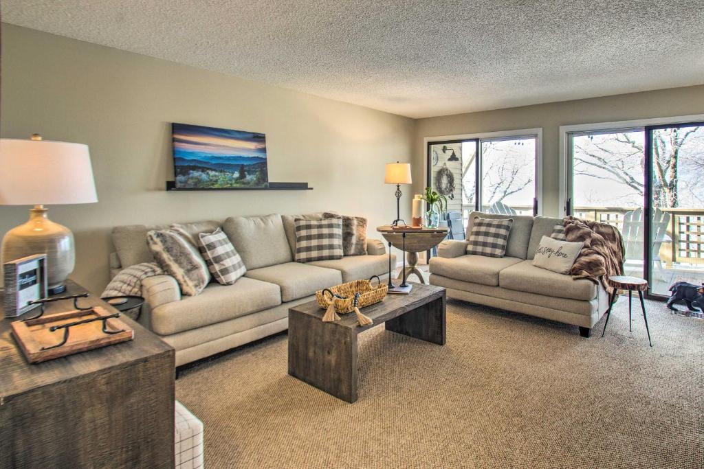 a living room with a couch and a table at Wintergreen Resort Condo Walk to Ski Lift! in Mount Torry Furnace