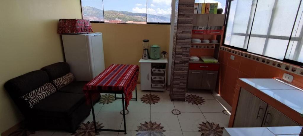 a kitchen with a bench and a table in a kitchen at cusco pasay in Cusco