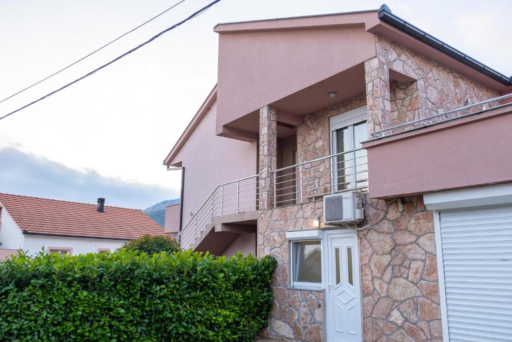 a house with a balcony on the side of it at Apartments Solar Trebinje in Trebinje