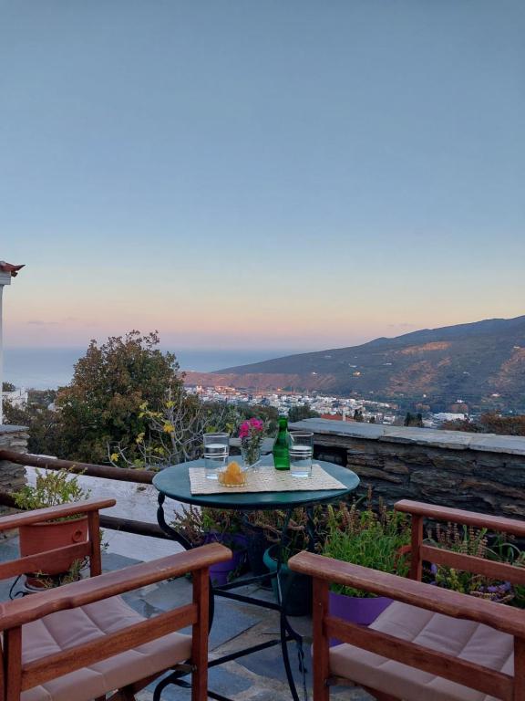 a table and two chairs on a patio with a view at Xenia's Traditional House in Andros