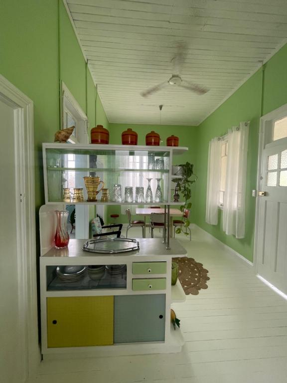 a kitchen with green walls and a counter with a sink at Avalon II in Innisfail