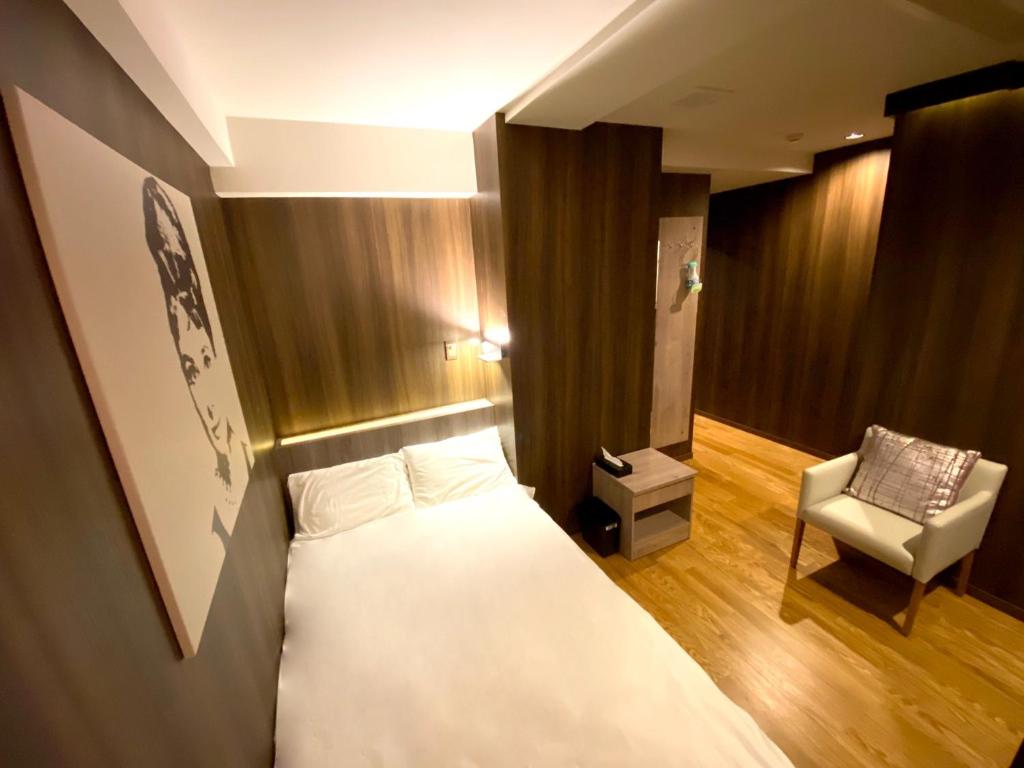 una camera d'albergo con letto e sedia di hotel mio omiya - Vacation STAY 64001v a Saitama