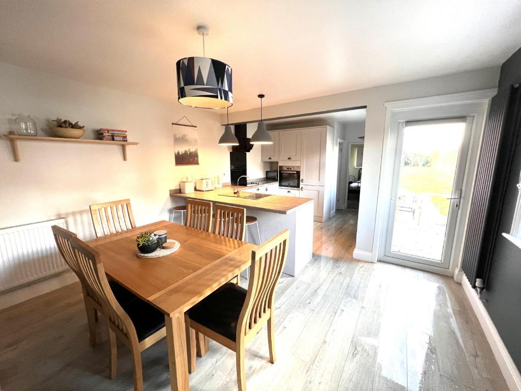 a kitchen and dining room with a wooden table and chairs at Belmont in Southampton