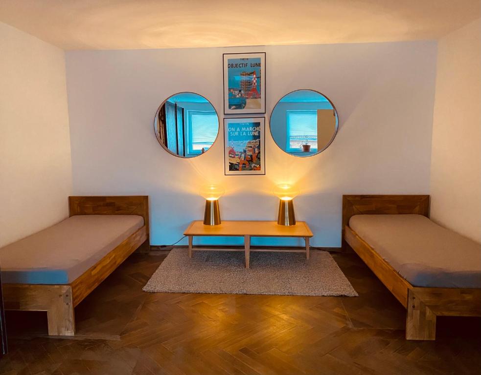a room with two beds and two mirrors at Studio/Loft in Eberswalde in Eberswalde-Finow