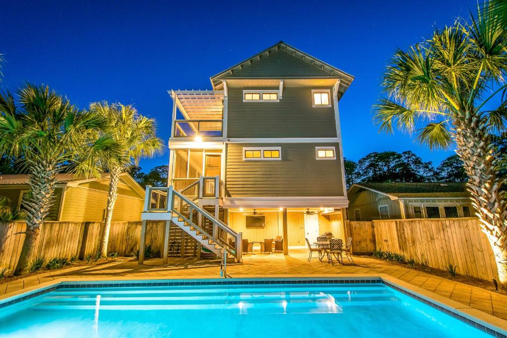 a house with a swimming pool in front of a house at Southern Grounds in Santa Rosa Beach