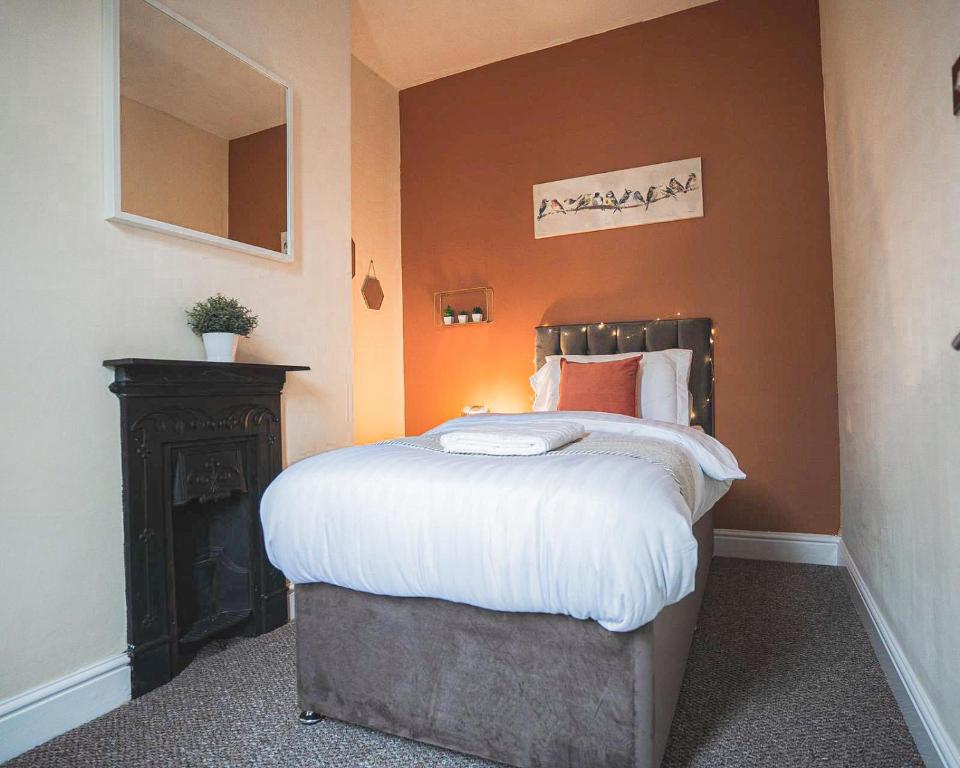a bedroom with a bed and a fire place at DIGS Cosy stay Coventry City Centre sleeps5 with FREE parking in Coventry