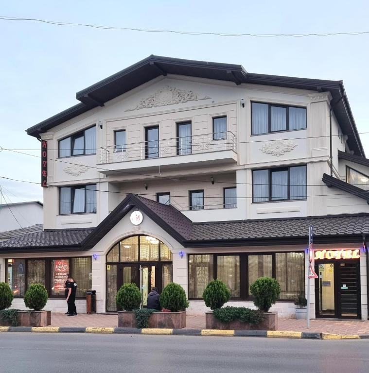 a man standing in front of a building at Hotel Bacsoridana in Tecuci