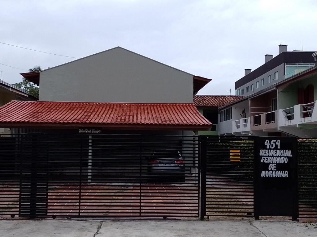 a building with a garage door with a sign on it at Casa Matinho Parana Praia Brava Praia Caioba Praia Mansa in Matinhos