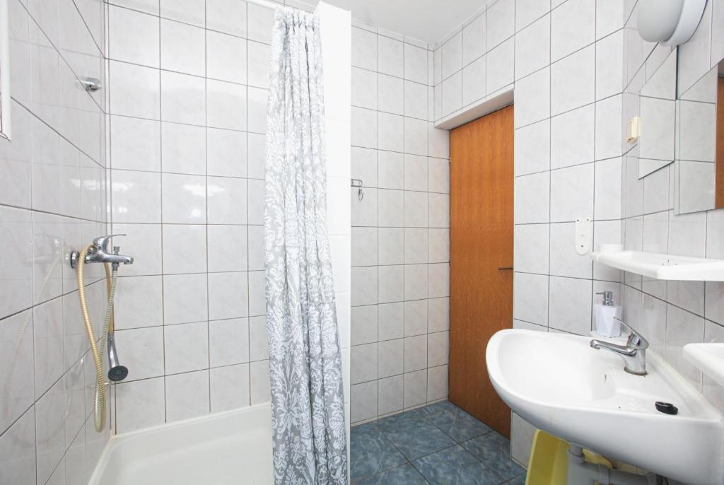 a bathroom with a tub and a sink and a shower at Apartments with a parking space Pirovac, Sibenik - 15320 in Pirovac