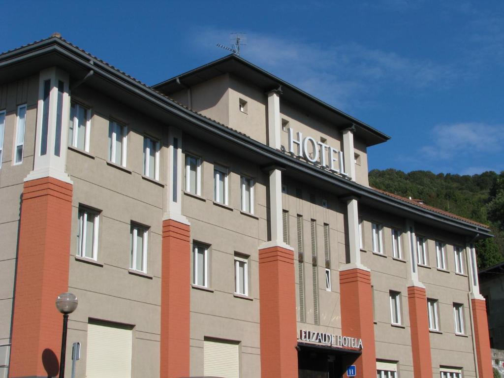a building with a hospital sign on the top of it at Hotel Elizalde in Oiartzun