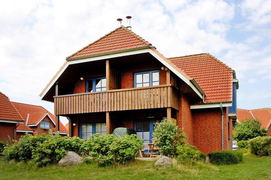 a brick house with a gambrel roof at Holiday resort Lemkenhafen, Fehmarn-Lemkenhafen in Lemkenhafen auf Fehmarn
