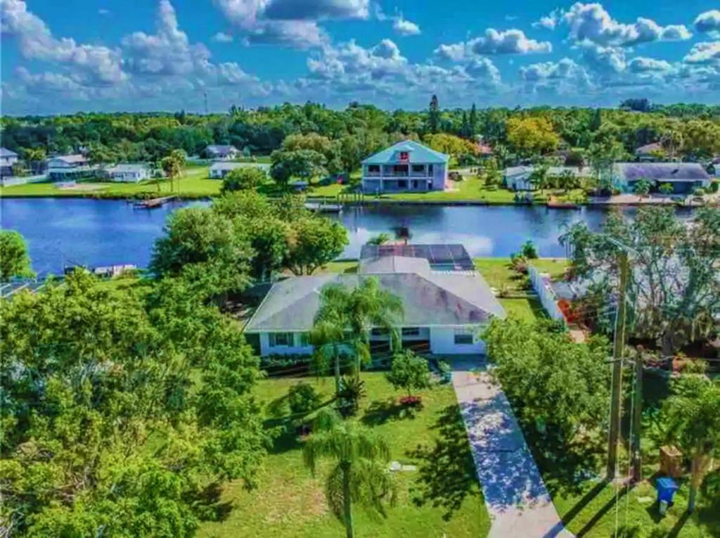 an aerial view of a house with a lake at Blue Heron House, Private 4 BR Waterfront w Heated Pool and Fire Pit in Ruskin