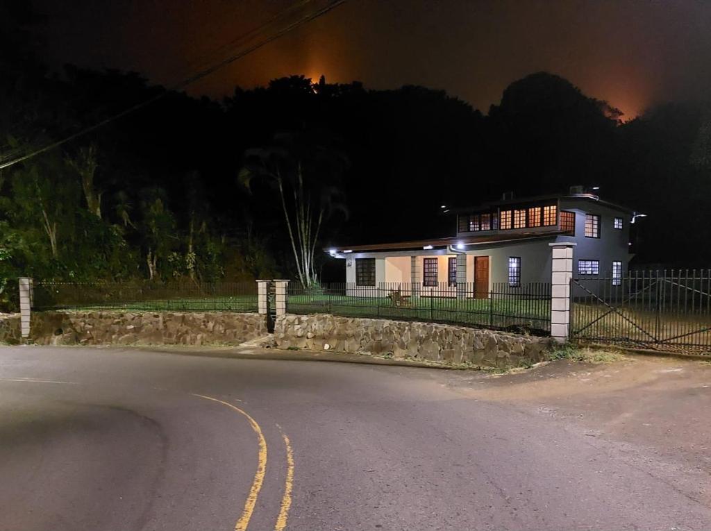 a house on the side of a road at night at Your Perfect Home Away From Home! in San Ramón