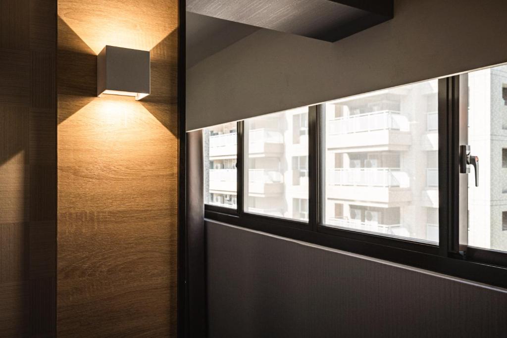 a window in a room with a view of a building at Global Traveler Hotel in Kaohsiung