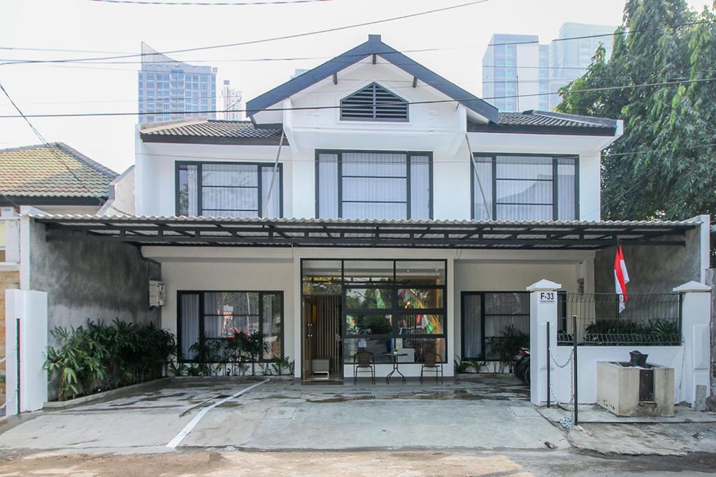 a white house with a lot of windows at TwoSpaces Living at Kencana Residence in Gunungsan