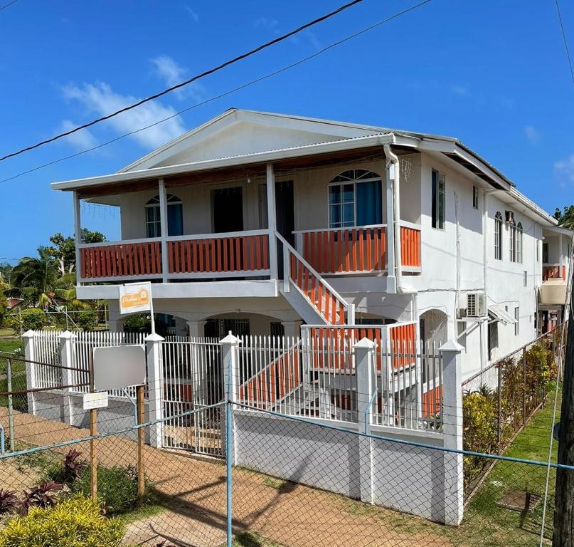 a white house with a fence in front of it at Christina's Guest House OFFICIAL in Little Corn Island