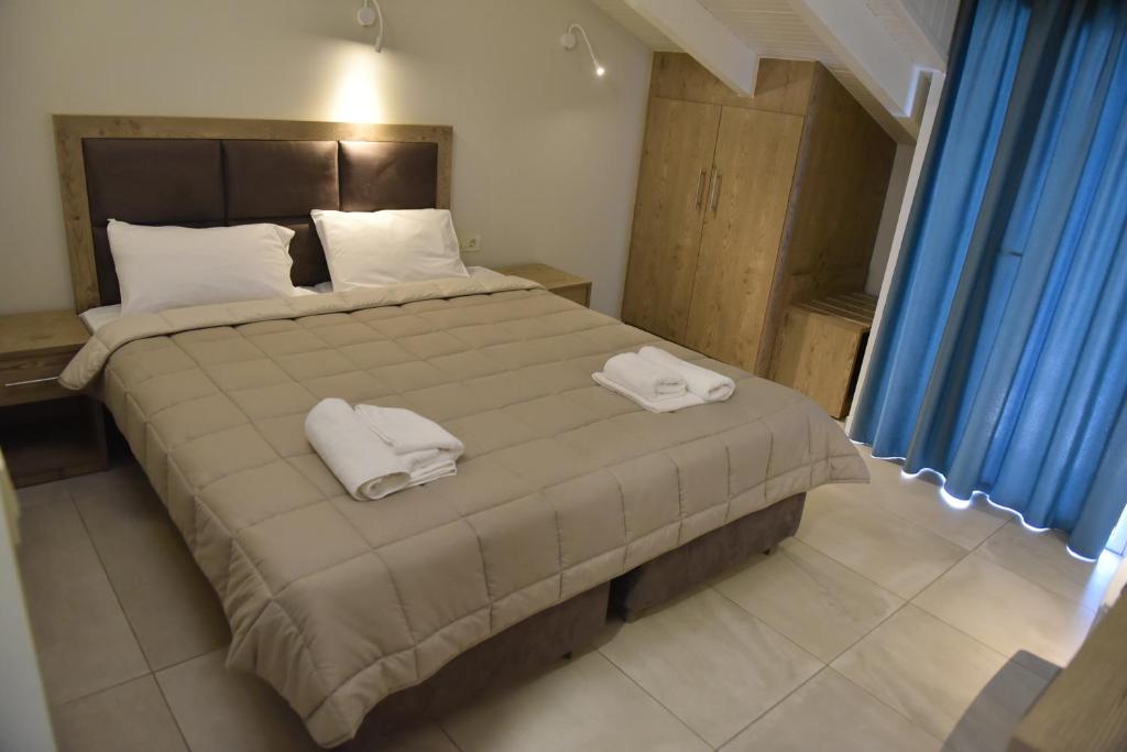 Postel nebo postele na pokoji v ubytování ZAKROS HOTEL