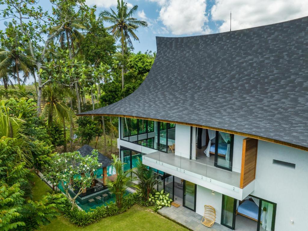 an aerial view of a house with a roof at Villa Satiya - Unique and stylish 4-bdr pool villa in Pererenan! in Canggu