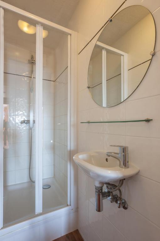 a bathroom with a sink and a shower and a mirror at Résidence Pierre &amp; Vacances Emeraude in Belle Plagne