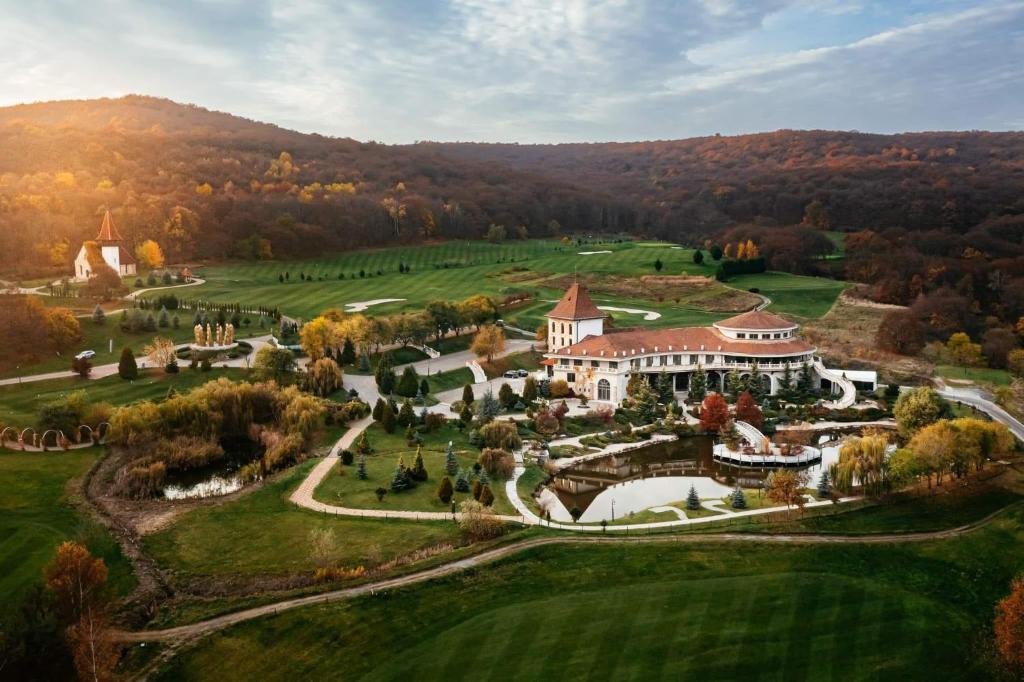 an aerial view of a mansion on a golf course at Sungarden Golf & Spa Resort in Cluj-Napoca