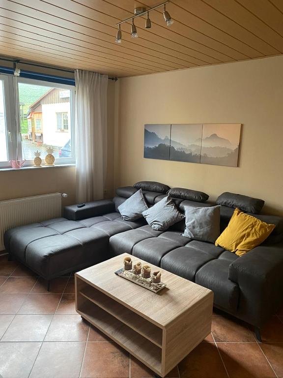 a living room with a couch and a coffee table at Ferienwohnung Schanz in Konken