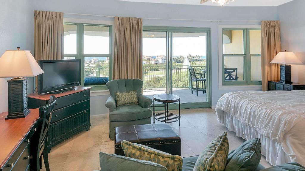 a hotel room with a bed and a television at Inn At Seacrest 405 in Rosemary Beach