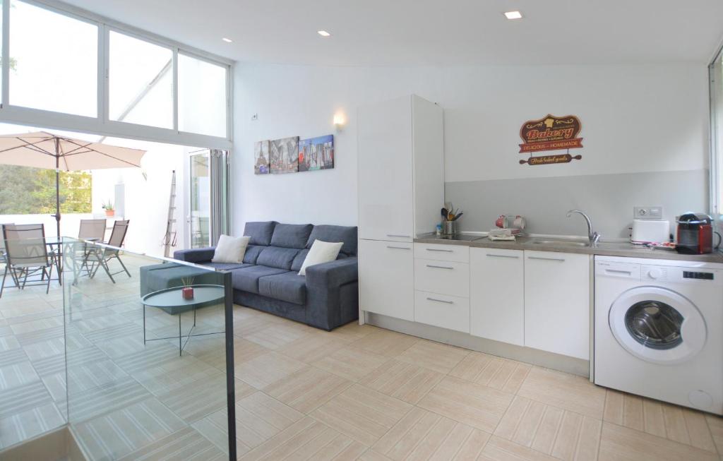 a kitchen and living room with a couch and a table at House 200m from Puerto de Sóller Beach in Port de Soller