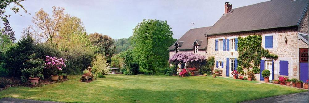 a house with a yard with flowers and plants at Captains Cabin, private appartement neuf dans vielle maison campagne in Saint-Priest-la-Plaine