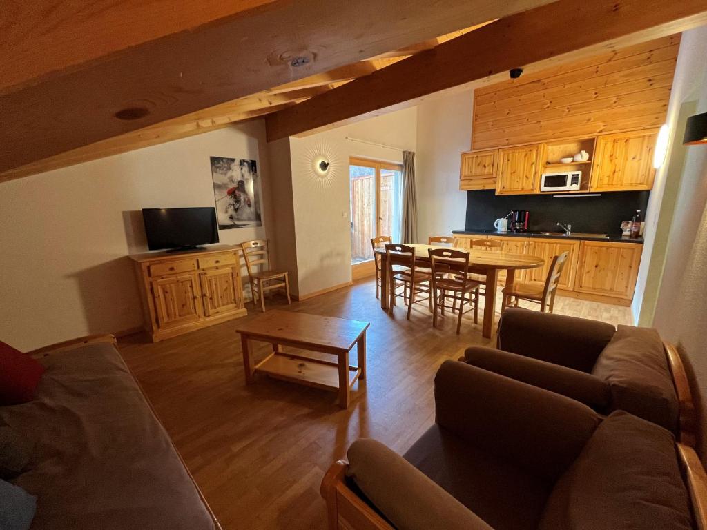a living room with a couch and a table at Pracondu 2 504 - OUTDOOR & FUN charming apartment 8 personnes in Nendaz