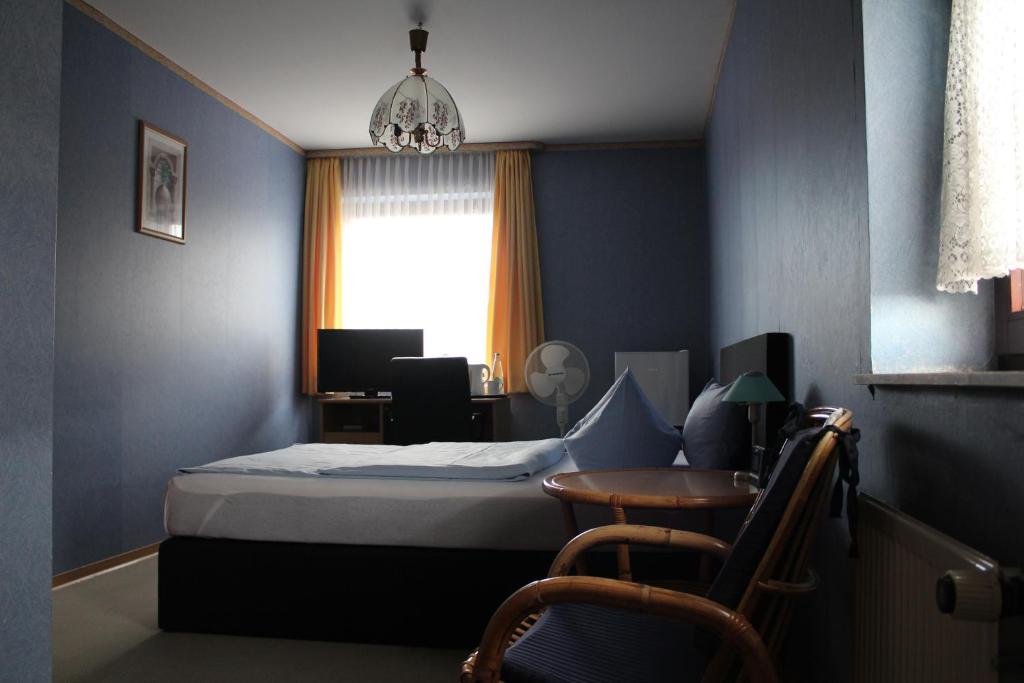 Postel nebo postele na pokoji v ubytování Occhipinti Passione - Restaurant & Hotel - Weyhausen