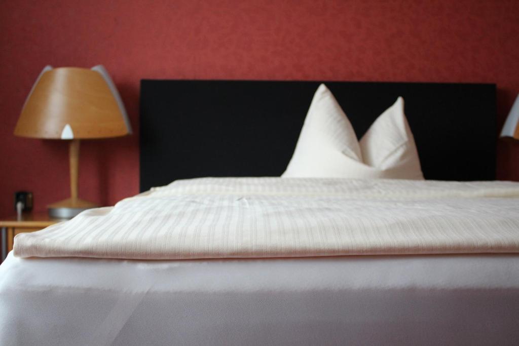 Postel nebo postele na pokoji v ubytování Occhipinti Passione - Restaurant & Hotel - Weyhausen