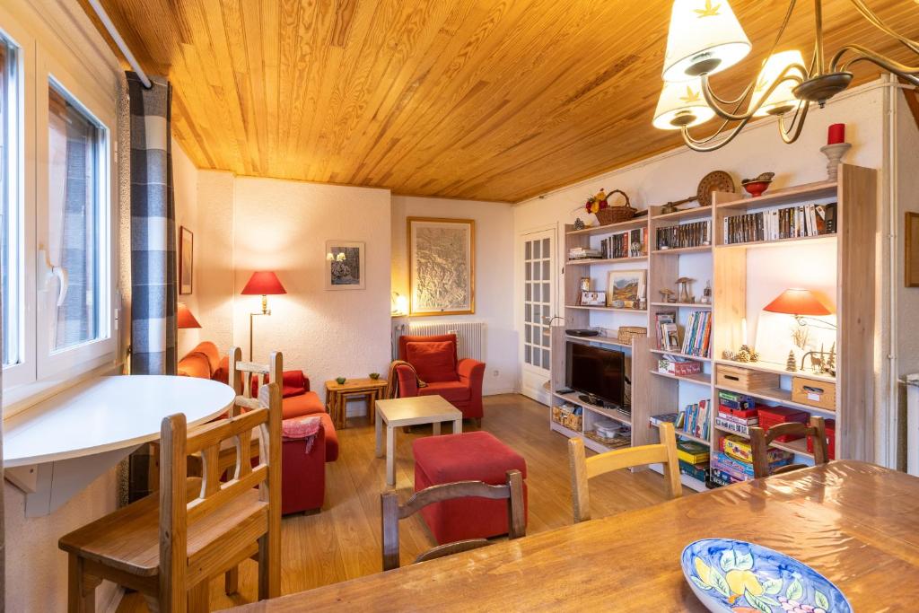 a living room with a wooden ceiling at Carols in Font-Romeu-Odeillo-Via