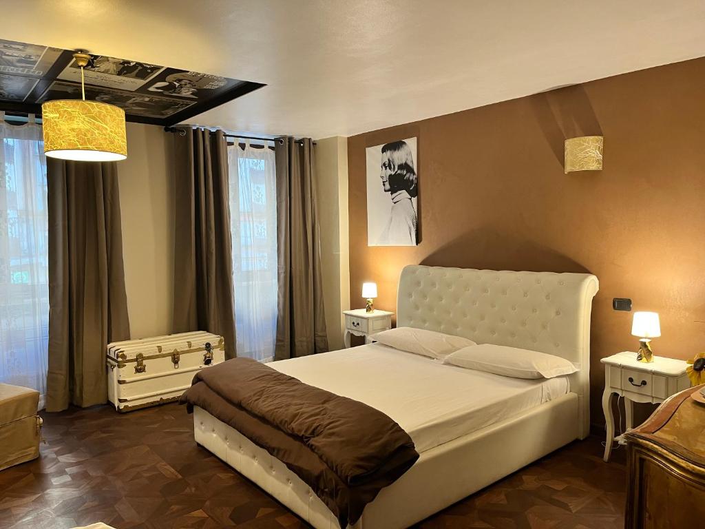 a bedroom with a white bed and two night stands at Torino Chic in Turin