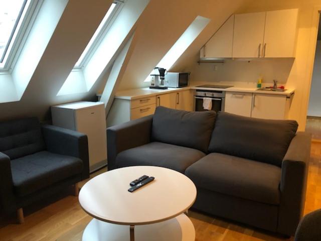 a living room with a couch and a table at Fløyen Apartment in Bergen