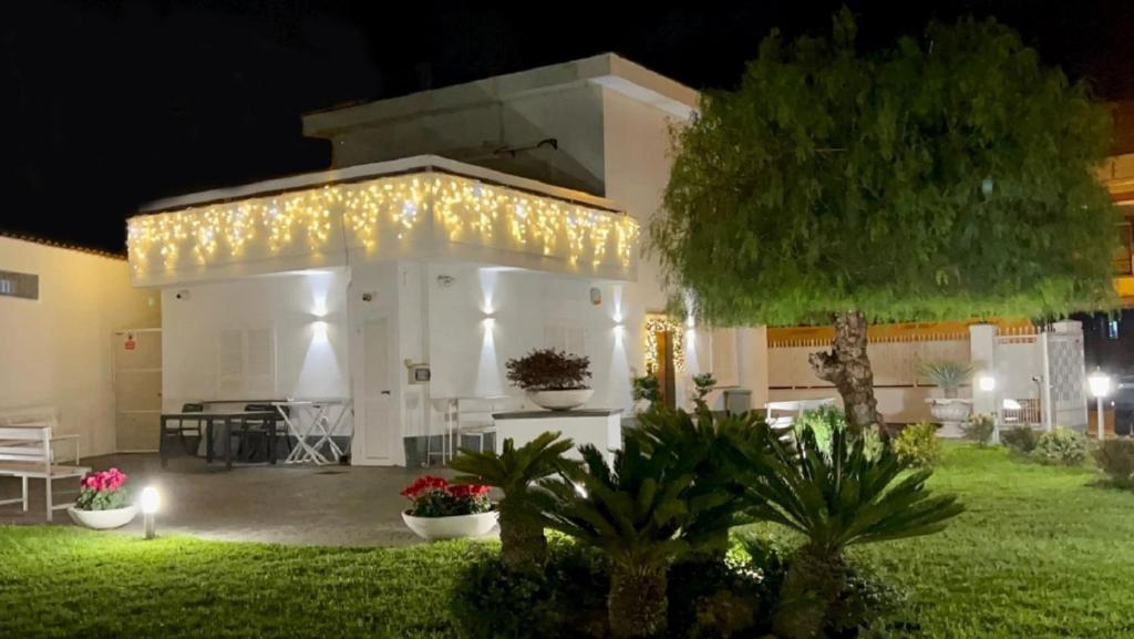 a white building with lights on it at night at Home Olympus Vesuvio in Pompei
