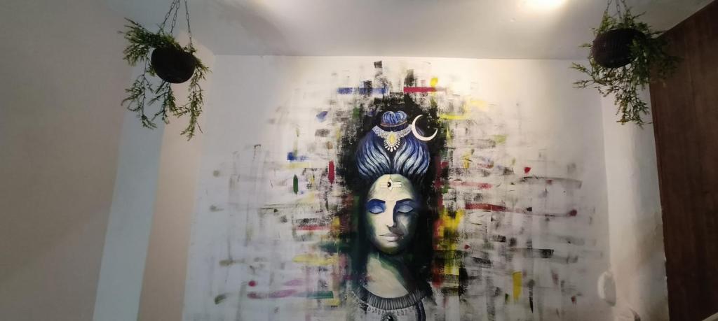 a painting of a woman on a wall at BlueStays Hostel in Rishīkesh
