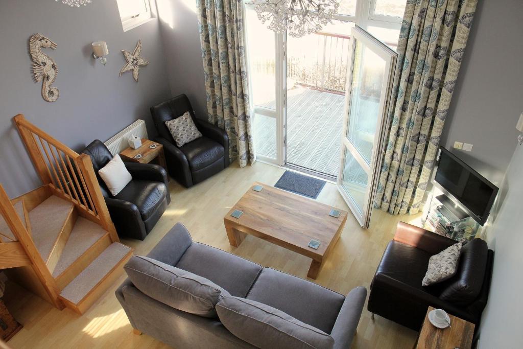 an overhead view of a living room with a couch and chairs at Seafront House, Westward Ho! in Westward Ho