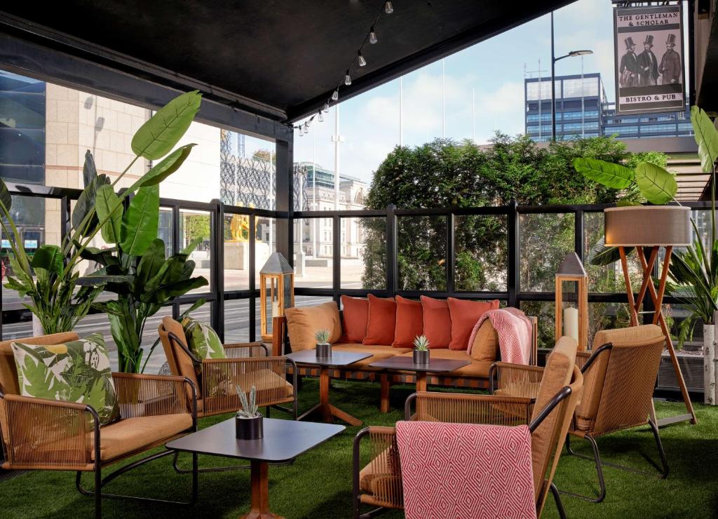 a patio with a couch and tables and chairs at Hyatt Regency Birmingham in Birmingham