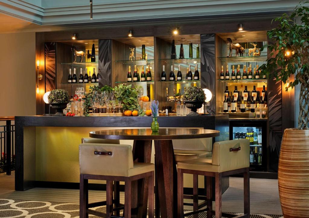 a bar with a table and some bottles of wine at Hyatt Regency Birmingham in Birmingham