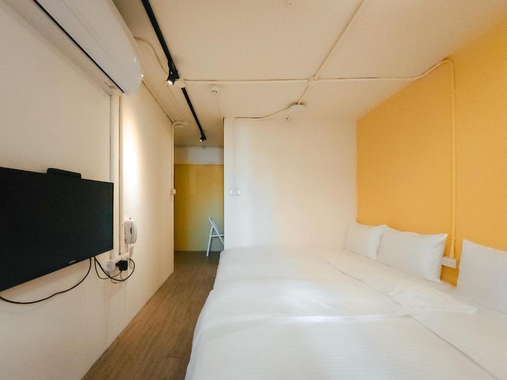 Postel nebo postele na pokoji v ubytování Taipei Inn