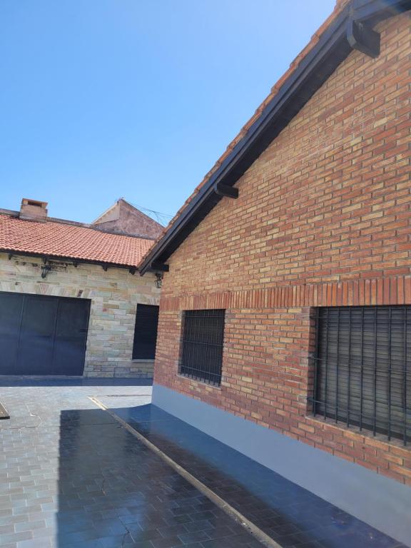 a brick building with a parking lot in front of it at Casa frente al mar Monte Hermoso in Monte Hermoso