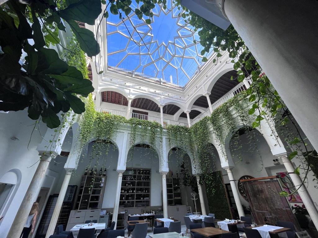 Blick auf das Thermium eines Gebäudes mit einer Glasdecke in der Unterkunft Palacio Pinello in Sevilla