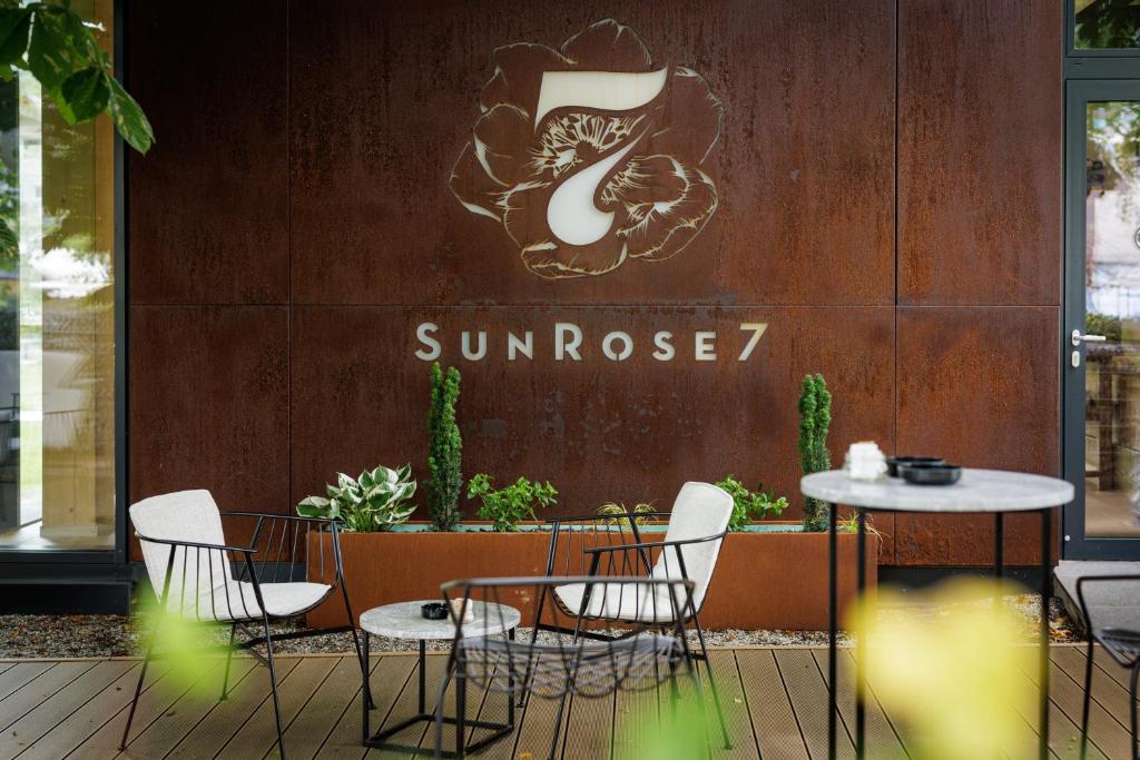 a table and chairs in front of a sunoco restaurant at Boutique Hotel Sunrose 7 - Gourmet & SPA in Bohinj