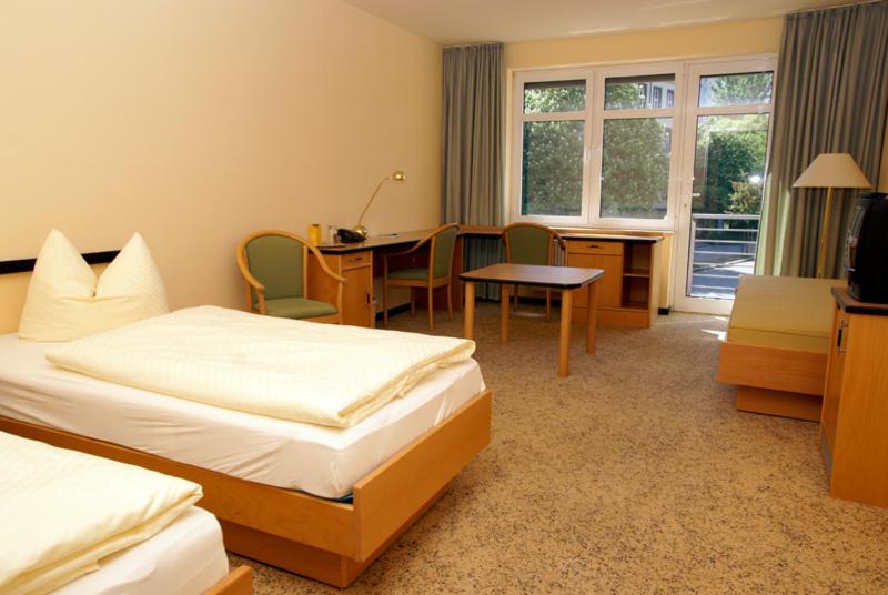 Postel nebo postele na pokoji v ubytování Hotel Am Weberplatz